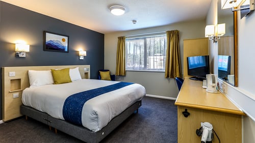 Bedroom with double bed, desk, TV and tea and coffee making facilities