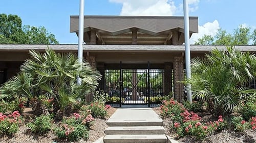 Swimming pool entrance surrounded by landscaping