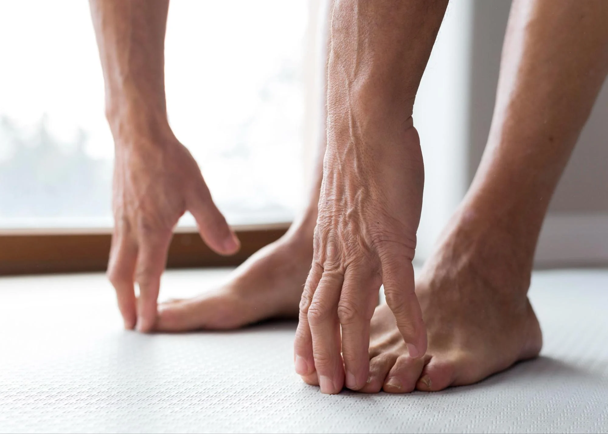 close up of person touching their toes