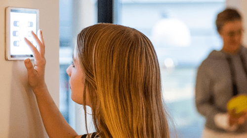 woman typing on wall mounted computer screen