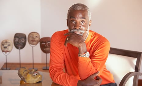 Man sitting at a table looking at the camera.