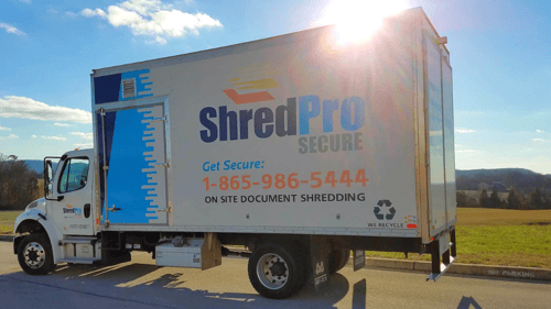 ShredPro Secure truck with the sun behind it