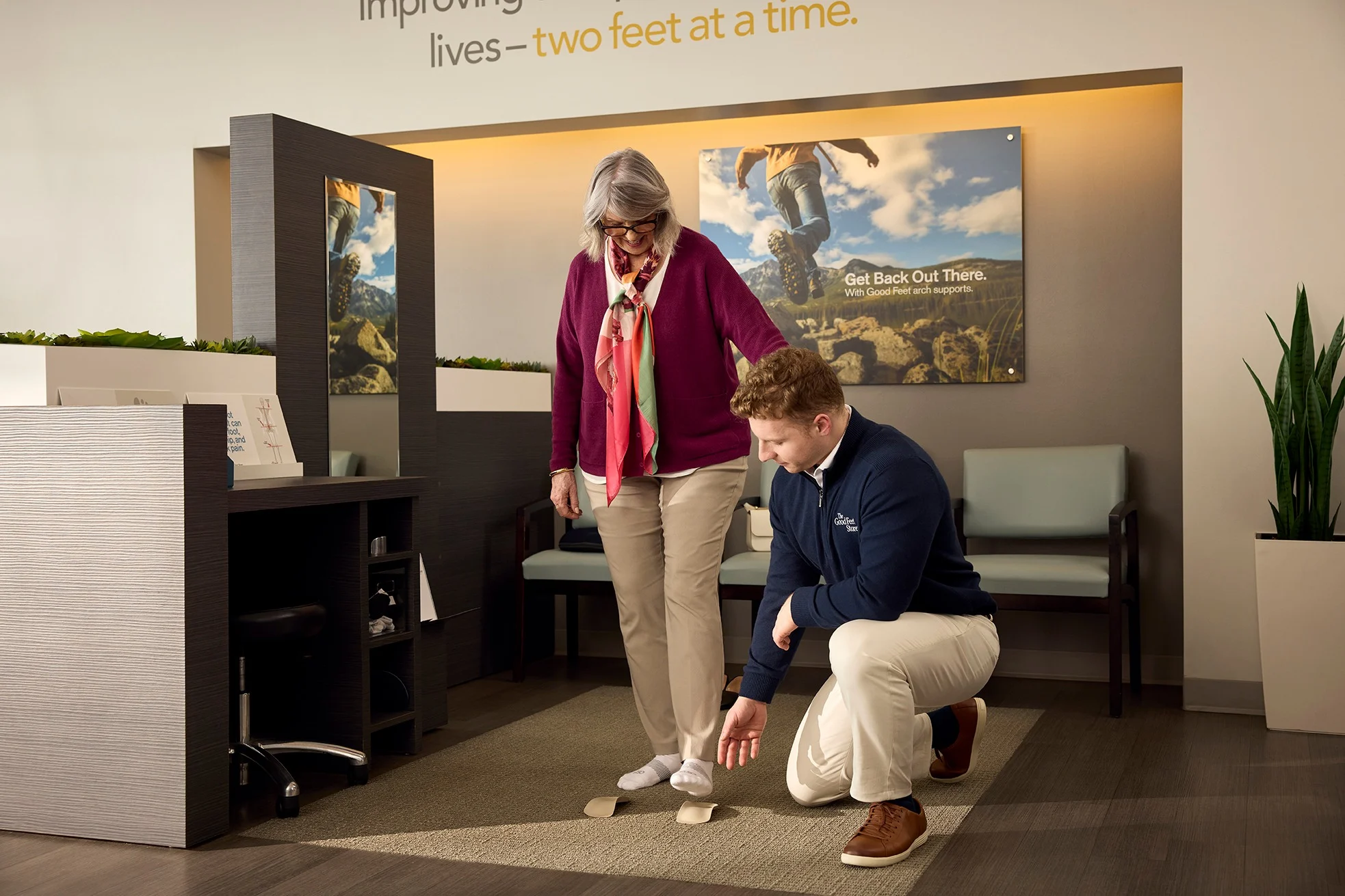 assistant helping woman find the right custom orthotics fit