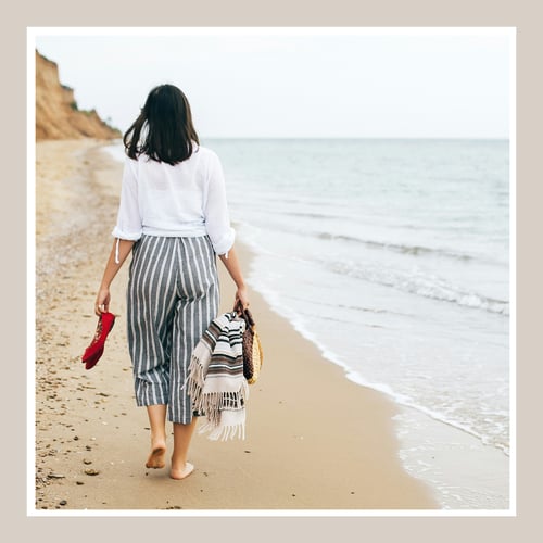 women walking solo on the beach