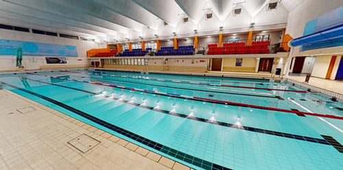 The main swimming pool at Tooting Leisure Centre and a pool-view seating area
