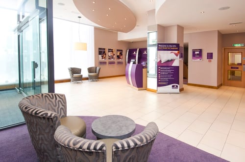 Premier Inn reception with check in desk and kiosks