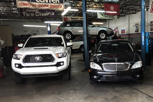 inside of shop with cars on lift