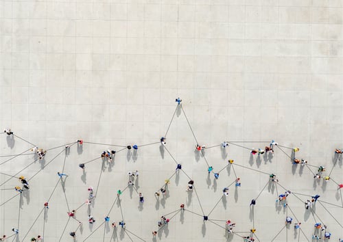 bird's eye view of people cluttered together on white patio below