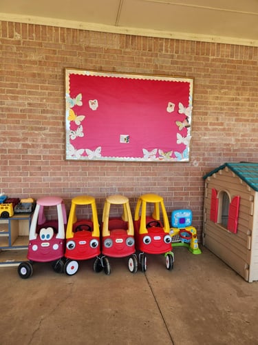 Toy cars lined up on the playground, ready for kids to hop in and enjoy hours of outdoor fun and imaginative play.