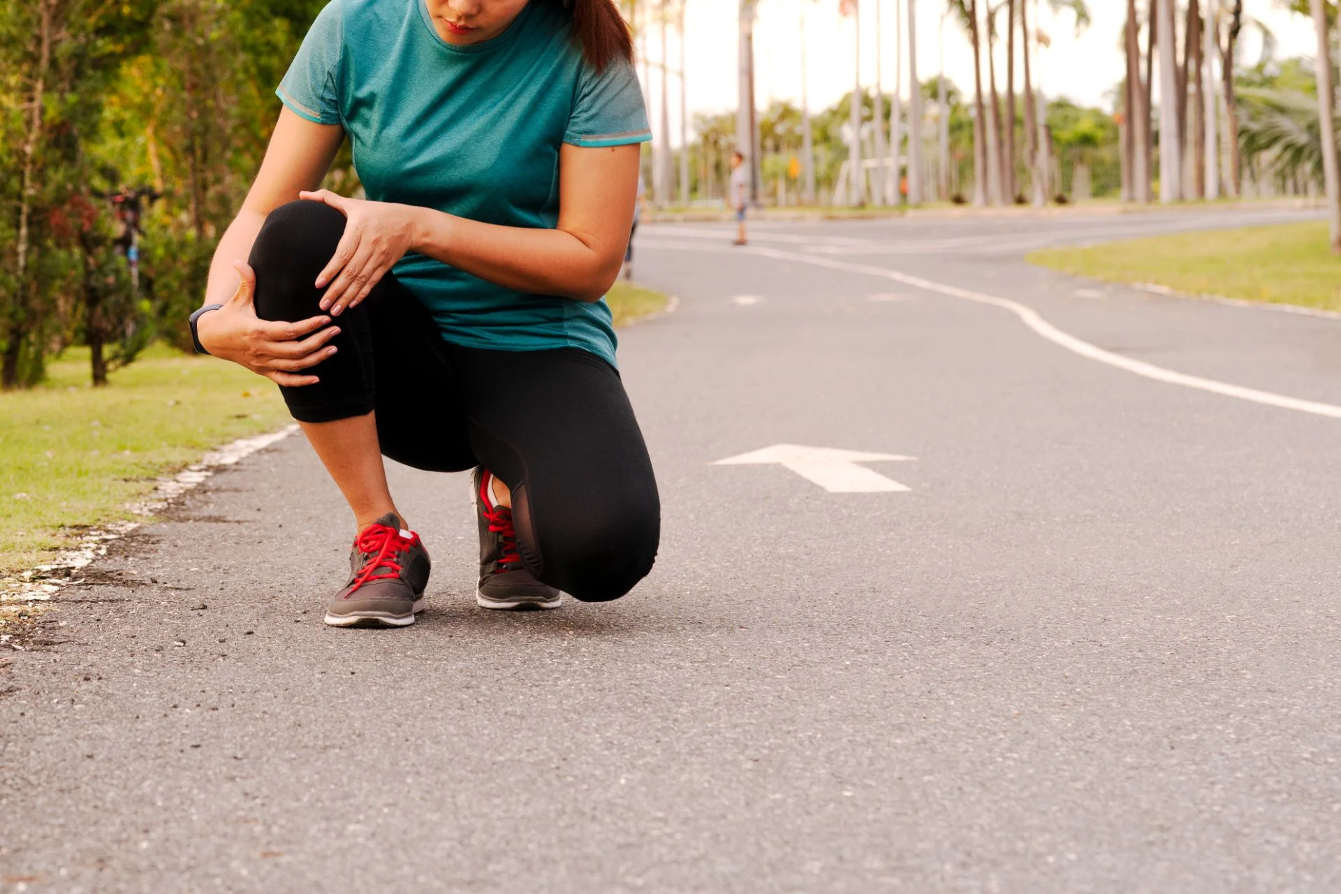 person experiencing knee pain on a walk
