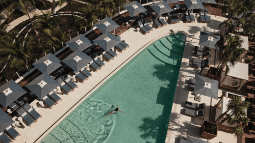 A swimmer enjoys the clear waters of a Four Seasons Hotel pool.