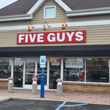 Exterior photograph of the Five Guys restaurant at 855 Montauk Highway in Shirley New York.