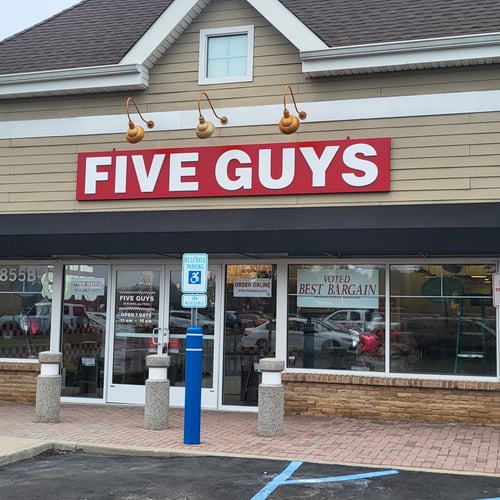 Exterior photograph of the Five Guys restaurant at 855 Montauk Highway in Shirley New York.
