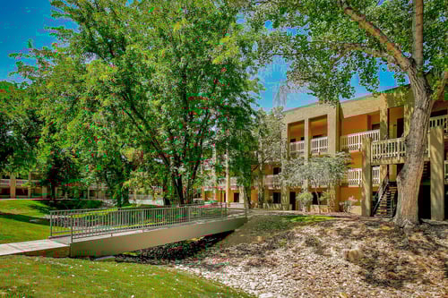 Exterior of apartment with trees at Pavilions at Pantano Apartments, Tucson, AZ, 85710