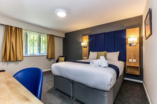 Bedroom with double bed and desk