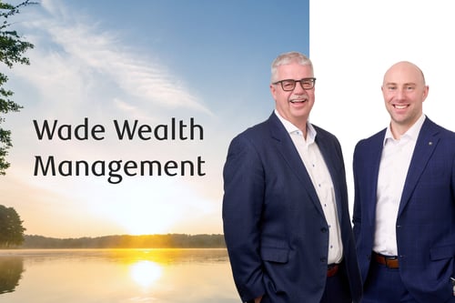 Frank Wade and Chris Cherepuschak standing in front of a lake at sunset.