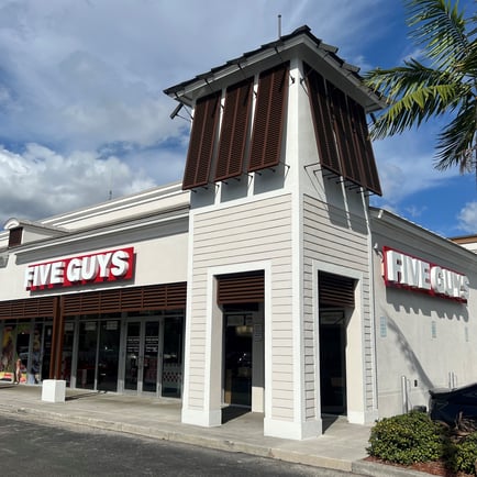 Exterior photograph of the Five Guys restaurant at 18421 NW 67th Avenue in Hialeah Florida.