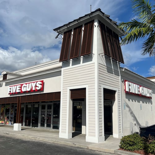 Exterior photograph of the Five Guys restaurant at 18421 NW 67th Avenue in Hialeah Florida.