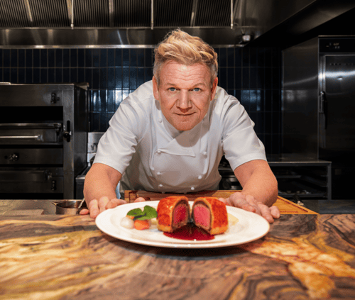 Gordon Ramsay serving his signature Beef Wellington steak.