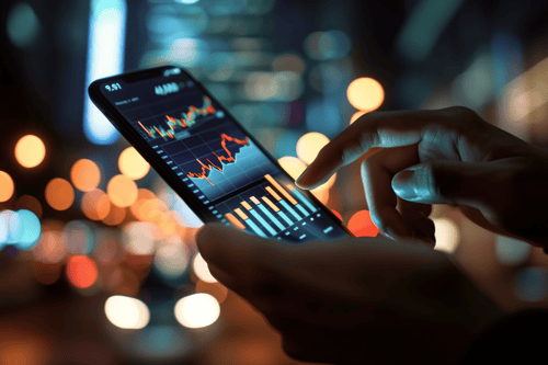 Person viewing stock market charts on a smartphone.