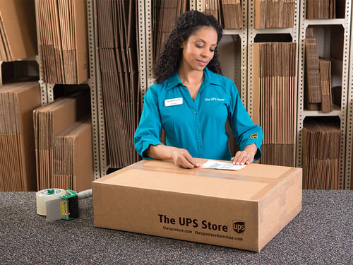 closing a shipping box with packing tape