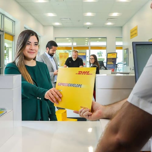 Woman shipping package at DHL Express Service Point