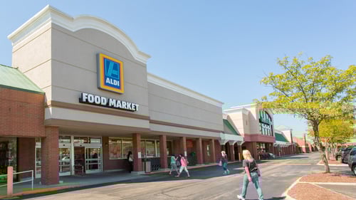 People walking towards entrance of Aldi Food Market at Watson Glen Shopping Center