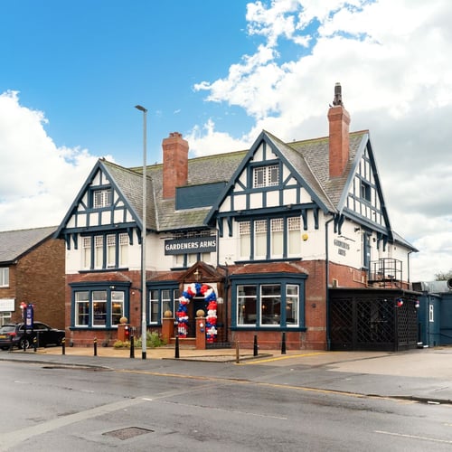 Exterior of The Gardeners Arms with signage and entrance