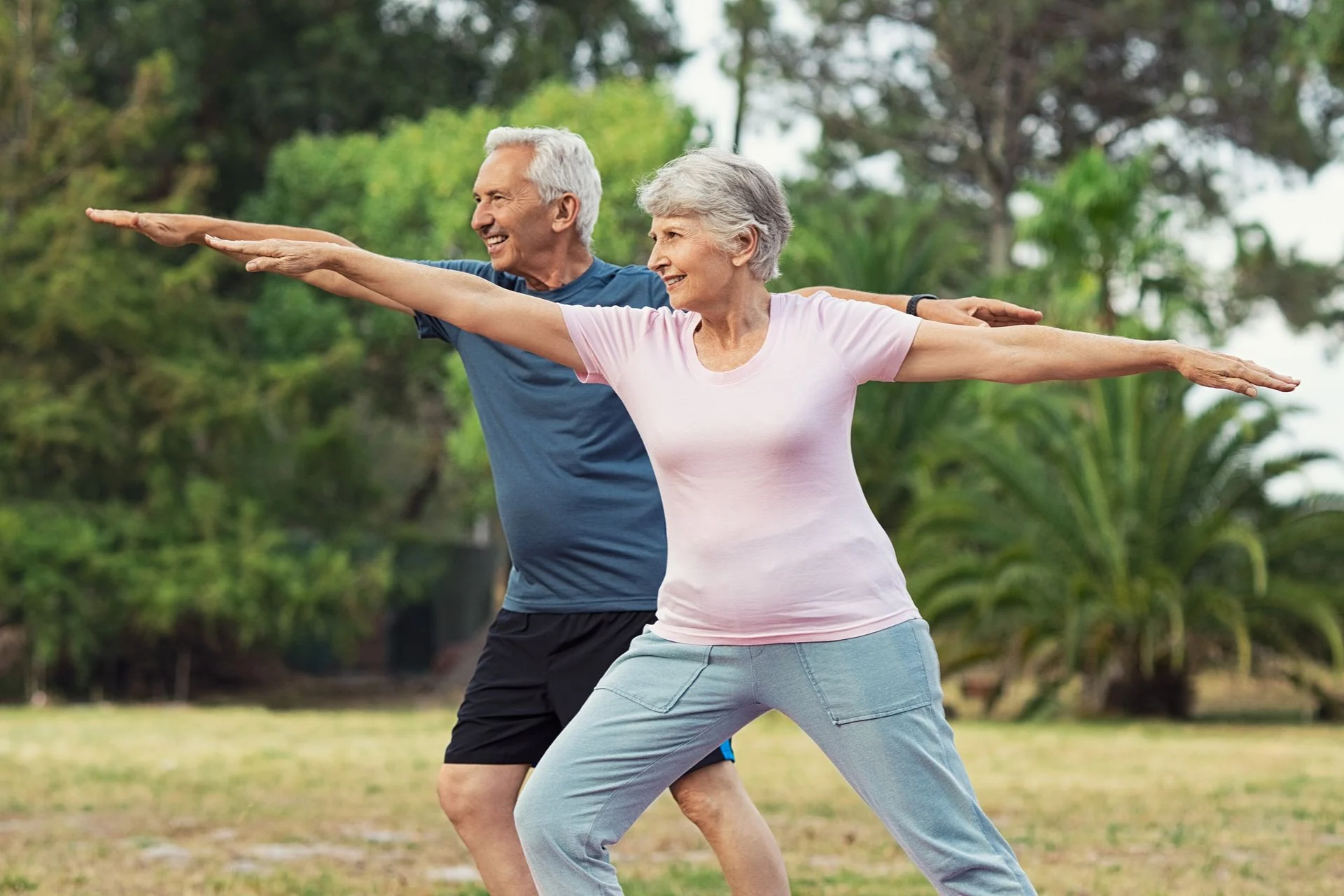 couple stretching outdoors to ease sciatic nerve pain