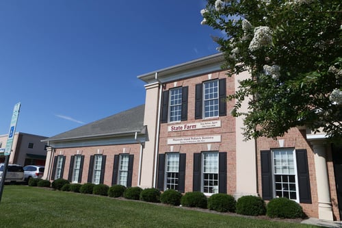 Brick building with black shutters