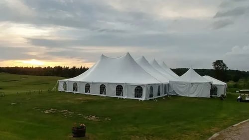 Large white enclosed tent outside