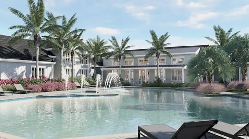 Large swimming pool with palm trees in front of a building at The Junction at Rockledge, Rockledge, FL 32955