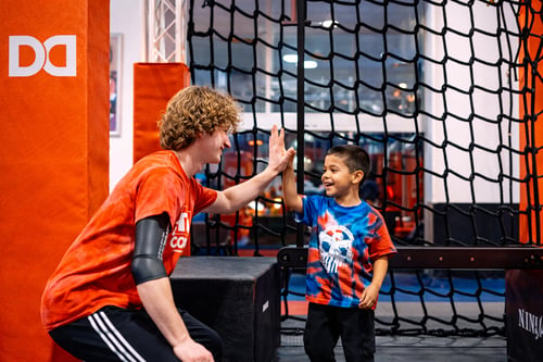 High five from gymnastics coach.