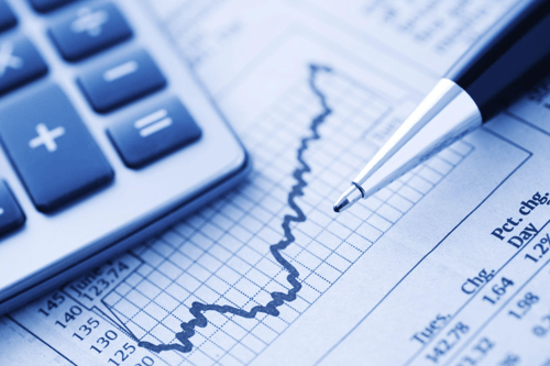 Close up of a pencil, calculator, and graph.