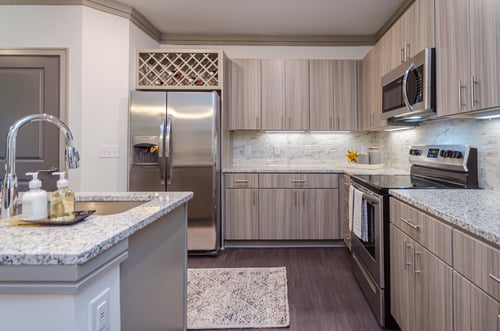 Kitchen with wine bottle storage in Camden Alpharetta apartments in Alpharetta, GA