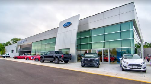 University Ford Durham dealership building with ford cars parked in front of it.