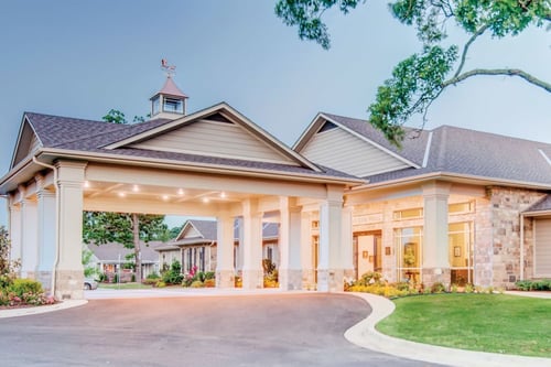 The Village on the Park Rogers building has a covered drop off area at the front of the building.