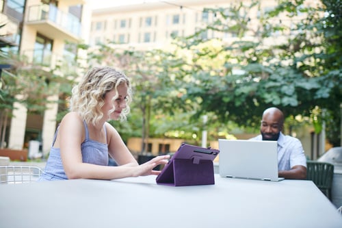 People using devices on public area