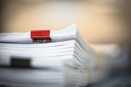 Pile of documents clipped together.