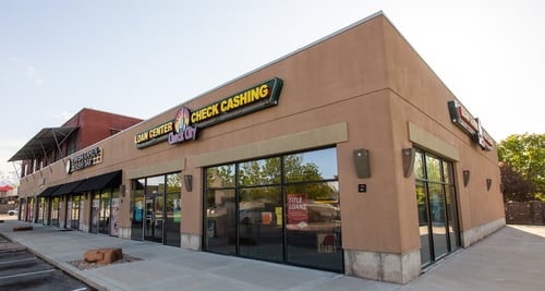 A brown building with the words 'Loan Center, Check Cashing' and the Check City Logo in the middle.