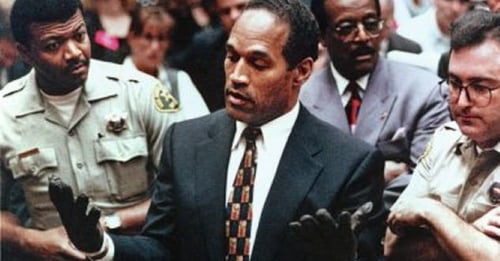 Orenthal James “O.J.” Simpson escorted by officers in court.