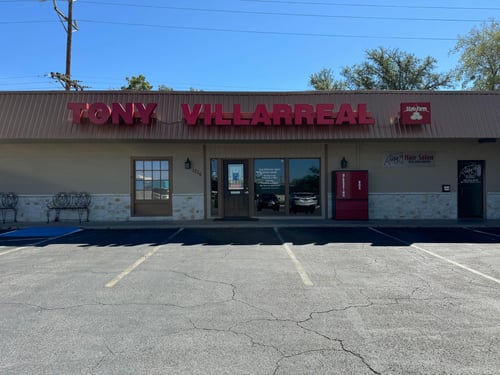 Brown building with red State Farm sign out front