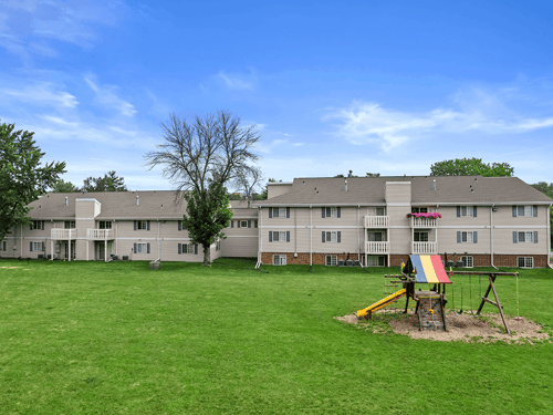 open green area with playground outside of Sun Valley apartments