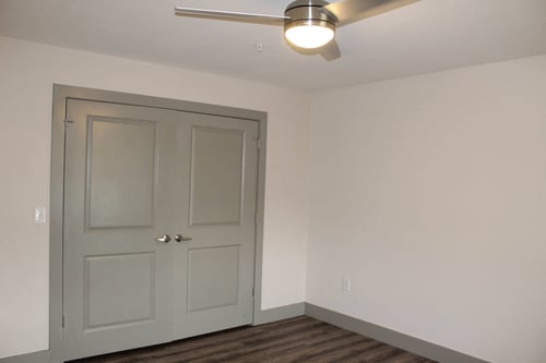 a room with a white door and a ceiling fan  at Haven Homes Apartments, in Plainfield, 46168