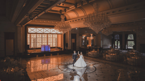 bride and groom alone on a large dance floor