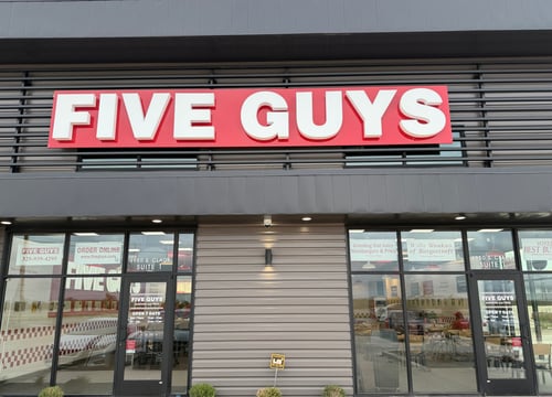 The exterior storefront of the Five Guys restaurant in Abilene, Texas.