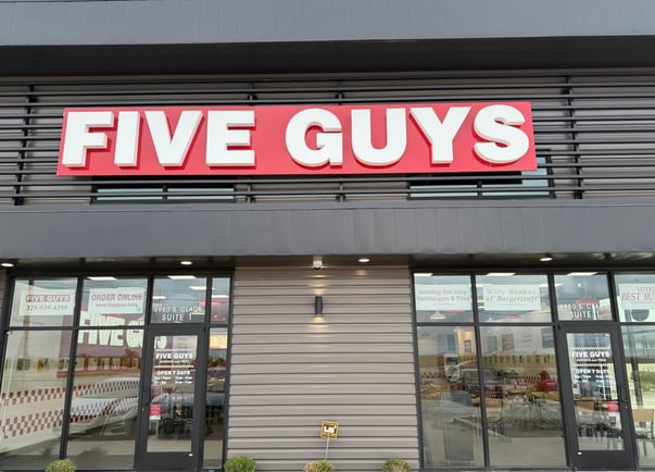 The exterior storefront of the Five Guys restaurant in Abilene, Texas.
