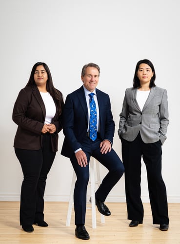 Michael, Sonal and Cece standing against white backdrop