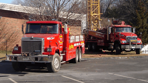 two red service trucks