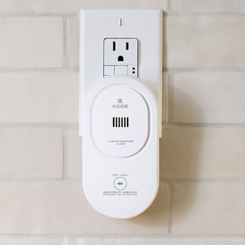 A Carbon monoxide alarm is plugged into a wall outlet.